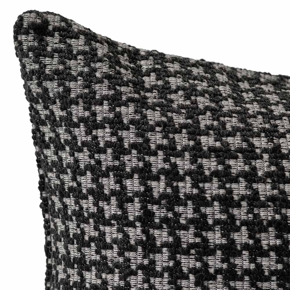 The Noirstone Lumbar Black-and-White Cushion by Urban Road (50x30cm) features a houndstooth pattern, ideal for enhancing interiors. Inspired by Darren Palmer and displayed on a crisp white background.