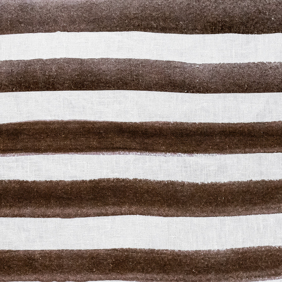 The Rumi Striped Chocolate Linen Cushion by Urban Road features horizontal brown and white stripes with a hand-painted effect, curved edges, and measures 50x50cm—a stylish accent for your home decor.
