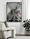 A modern living room showcases Urban Road’s "In Wonderland" (Black Box Frame Canvas, 120x90, Portrait), artfully depicting a zebra with a peacock, a flamingo, and a green-striped ball on a checkered floor, styled with a white armchair and green pillow.