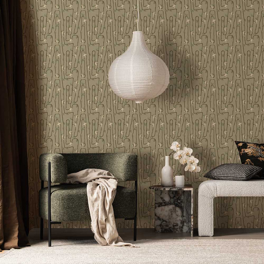 A young girl sits on a rug in a modern living room with a fluffy dog, plush toys, and cushions, all set against the Urban Road Giggly Bush Babies Wallpaper in soft olive green, adding a playful touch to the space.

