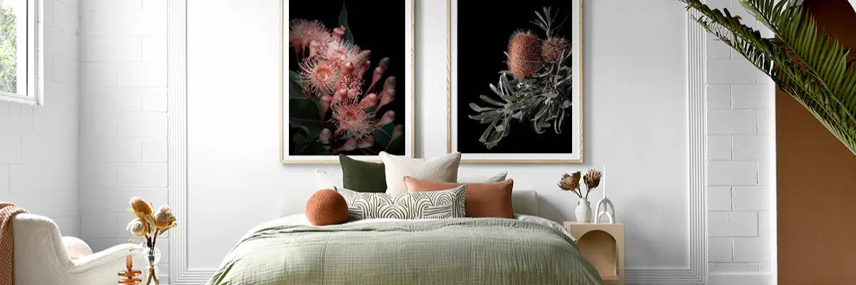 Calm bedroom showcasing dramatic floral and botanical artwork in deep colours, framed by contemporary bedroom decor.