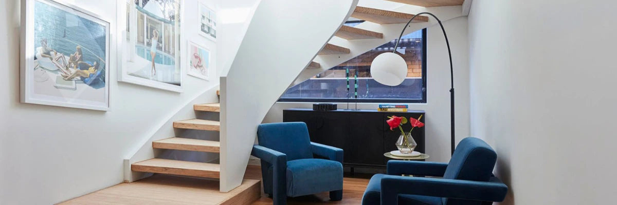 Stylish living space inspired by "The Block," showcasing modern coastal artworks and designer furniture with chic decor.