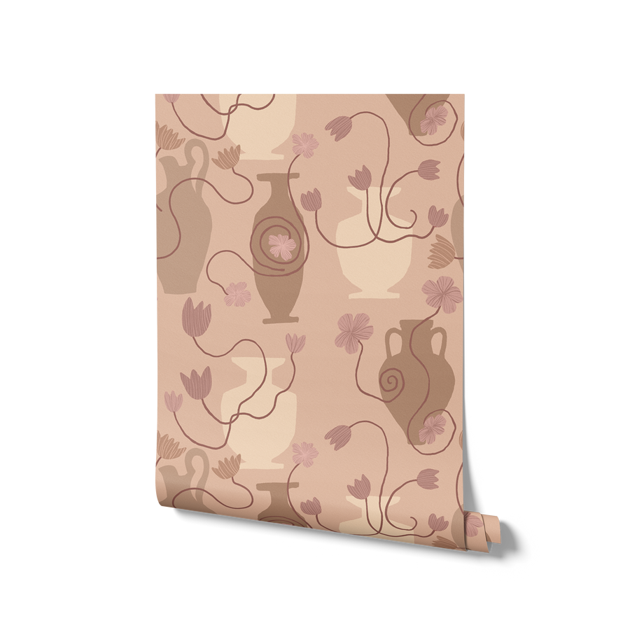 Light pink wallpaper featuring Grecian-inspired vases, trailing floral stems, and delicate blush-toned blooms, from the Shatha collection with Urban Road.