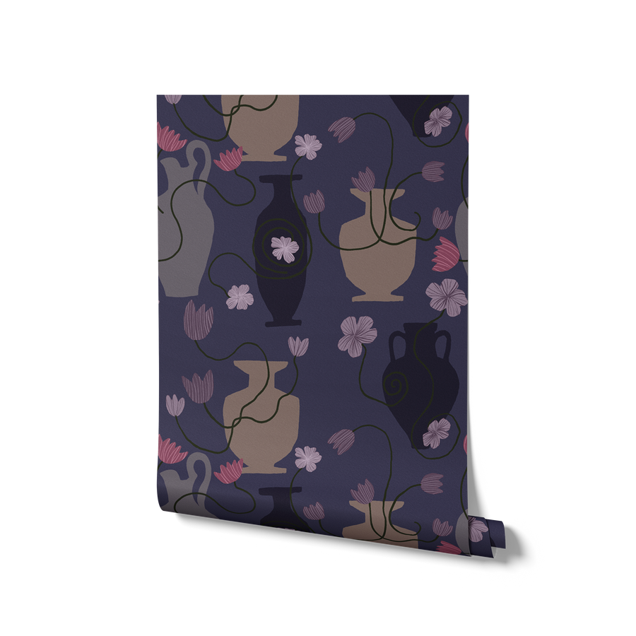 Striking navy wallpaper featuring pale and midnight vases with trailing green stems and soft lavender-pink flowers, from the Shatha collection with Urban Road.