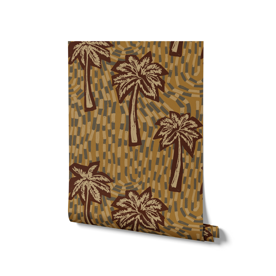 Earthy ochre wallpaper featuring stylised palm trees over a layered, hand-drawn tile texture background, from the Shatha collection with Urban Road.