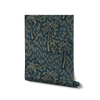 Inky teal wallpaper with soft beige palm illustrations layered over deep blue-green flowing strokes, from the Shatha collection with Urban Road.