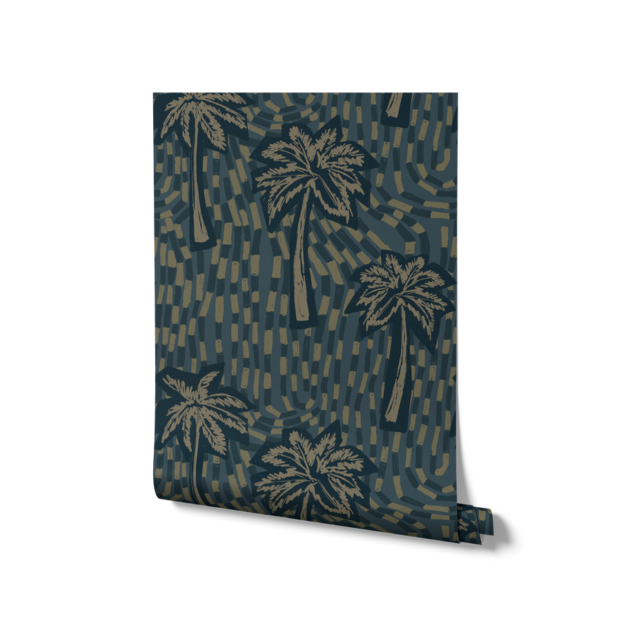 Inky teal wallpaper with soft beige palm illustrations layered over deep blue-green flowing strokes, from the Shatha collection with Urban Road.