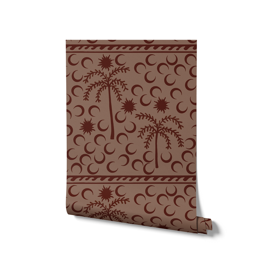 Rich dark brown wallpaper with chocolate palm silhouettes and moon patterns, topped with a subtle striped border, from the Shatha collection with Urban Road.