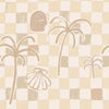 Neutral-toned wallpaper in sandy beige with a loose checker pattern, simple palm forms, and illustrated shell and face motifs, from the Shatha collection with Urban Road.