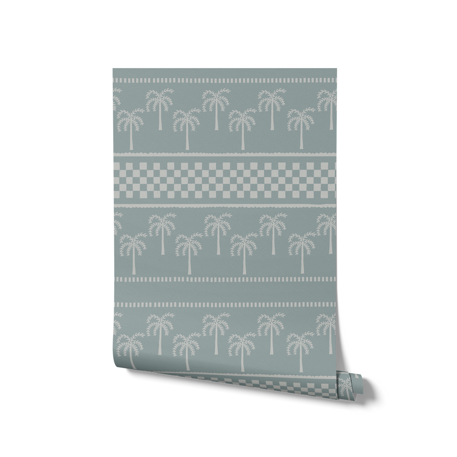 Cool blue wallpaper with rows of pale palms and decorative bands in soft ivory and light blue, from the Shatha collection with Urban Road.