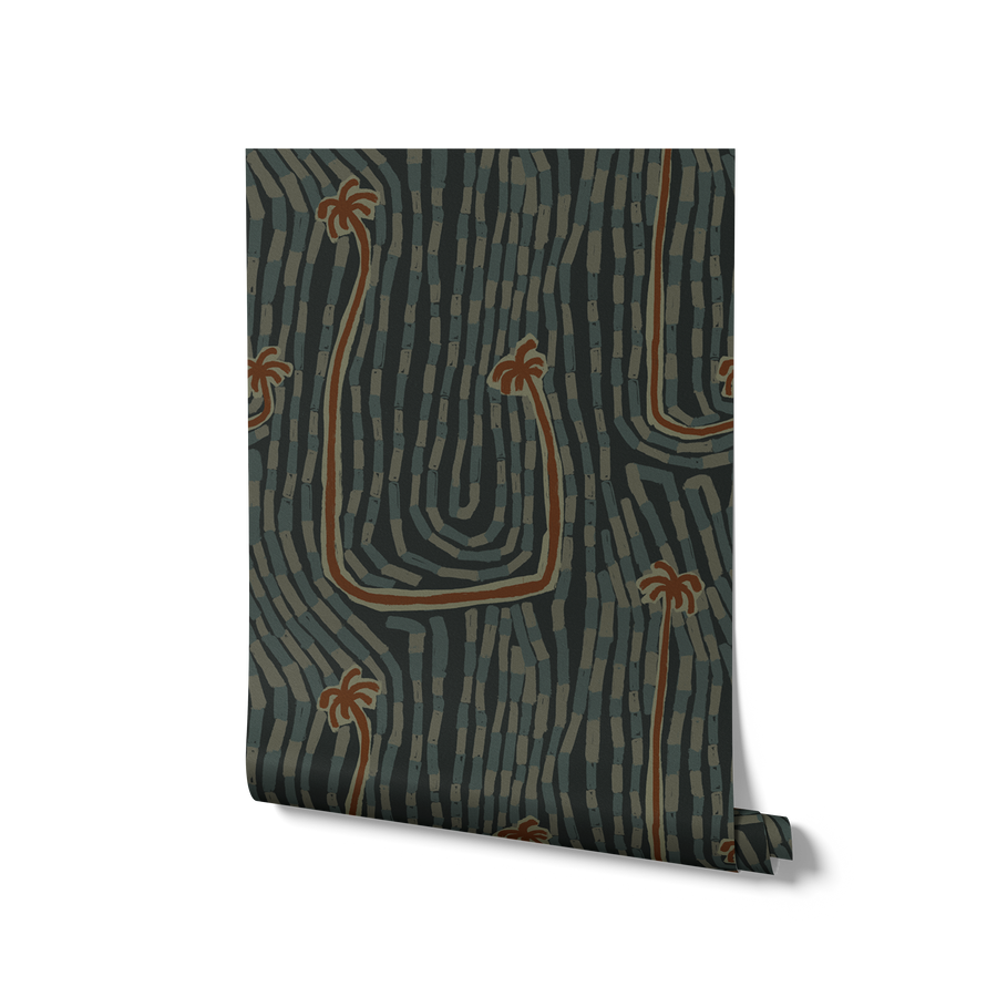 Deep teal wallpaper with warm-toned palm tops and wavy curved trunks layered on a rhythmic mark-filled backdrop, from the Shatha collection with Urban Road.