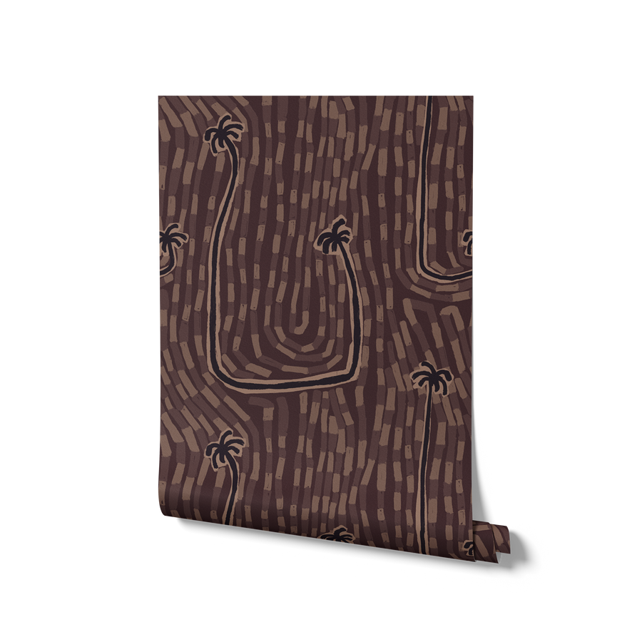 Warm earthy brown wallpaper with plum and rust palm details and hand-drawn wave-like linework, from the Shatha collection with Urban Road.