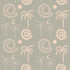 Mint green wallpaper with hand-drawn palm trees, swirling sunburst motifs, and crescent moons in pale cream, from the Shatha collection with Urban Road.