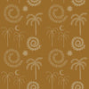 Golden ochre wallpaper decorated with whimsical cream palms, moons, and swirling sun forms, from the Shatha collection with Urban Road.
