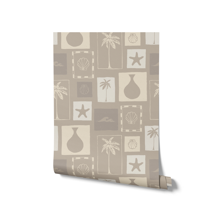 Stone-toned wallpaper with framed coastal icons—palm trees, shells, vases, and waves—arranged in a hand-drawn grid, from the Shatha collection with Urban Road.