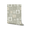Soft sage wallpaper with cream-toned framed tropical imagery—palm silhouettes, shells, and abstract coastal elements, from the Shatha collection with Urban Road.