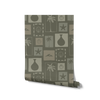 Dark green wallpaper with soft sage-framed tropical motifs—palms, sea elements, and ceramics—in a vintage-style layout, from the Shatha collection with Urban Road.