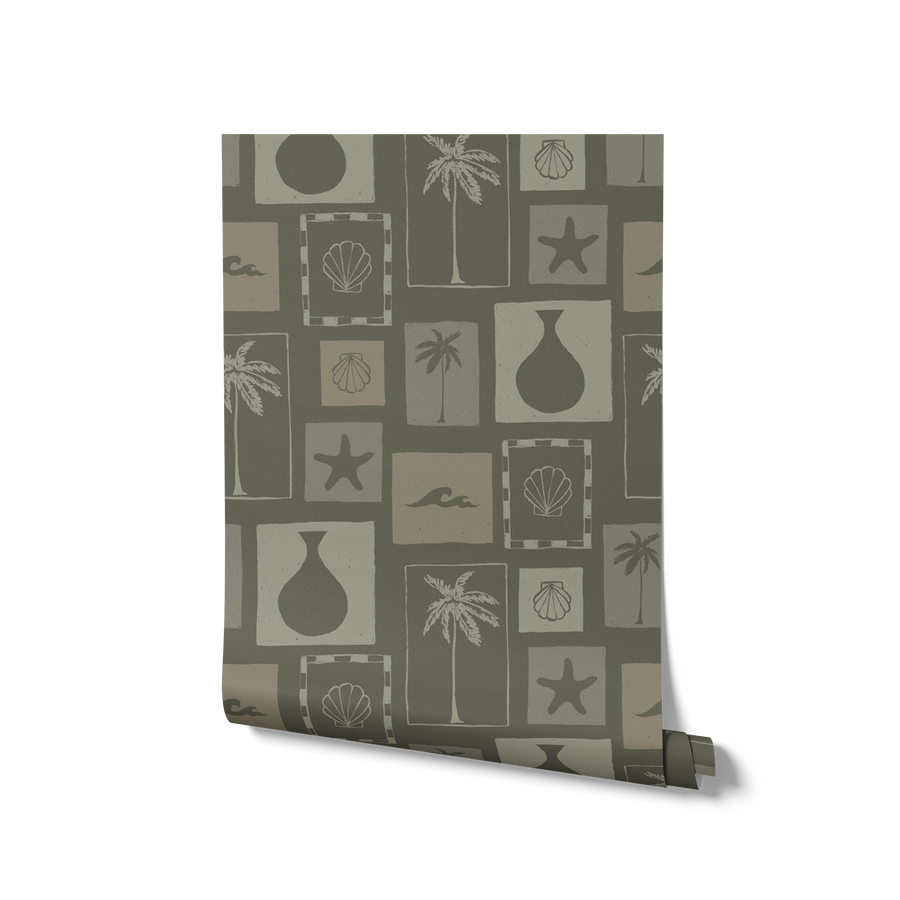 Dark green wallpaper with soft sage-framed tropical motifs—palms, sea elements, and ceramics—in a vintage-style layout, from the Shatha collection with Urban Road.