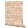 Wallpaper from the Tim Neve collection by Urban Road, with a soft peachy grid on a neutral base, offering a subtle, organic flow.