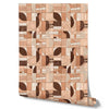 Wallpaper from the Tim Neve collection by Urban Road, showcasing a warm blush geometric mosaic with abstract shapes and soft contrasts.