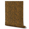 Wallpaper from the Tim Neve collection by Urban Road, with layered ochre and brown abstract lines and a geometric pattern.