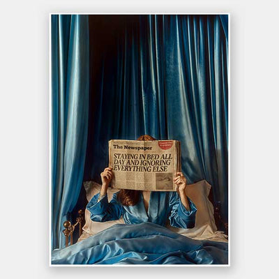The Morning Gossip Unframed Art Print by Urban Road features a person in blue pajamas reading a "STAYING IN BED ALL DAY AND IGNORING EVERYTHING ELSE" newspaper, adding subtle Palm Springs elegance to any space.