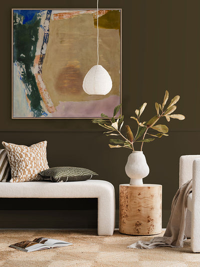 Desert Blush II abstract wall art print styled with neutral seating and decor, a checkered rug, and a dark brown wall.