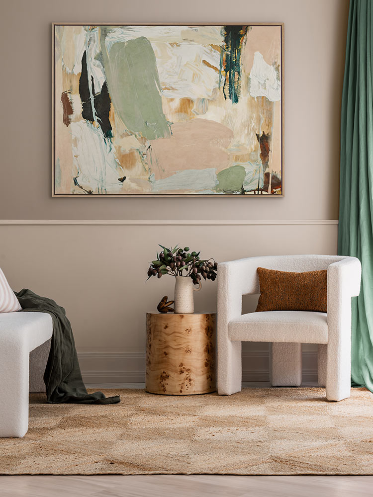 Earth Echoes II abstract artwork in a minimal living room with timber and white furniture and a soft textured rug.