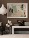 Earth Echoes II abstract artwork in a minimal living room with timber and white furniture and a soft textured rug.