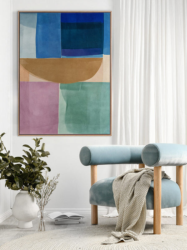 Sun Tiles I colourful abstract art print above a blue armchair with white curtains and modern decor in a bright room.
