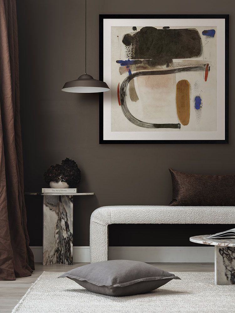 Homebound I expressive abstract art print featured above a bed in a warm, minimal bedroom with rich brown textiles.