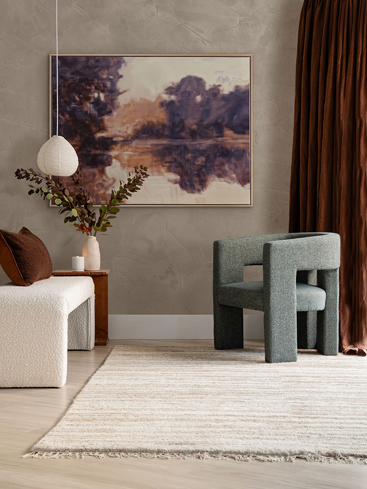 Sunset at Lavender Lake I landscape art print hangs above a grey chair in a neutral room with floral decor and moody drapery.