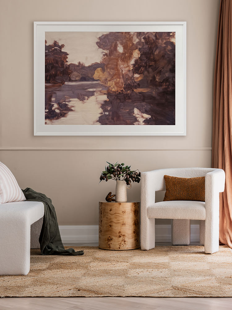 Sunset at Lavender Lake II landscape artwork above a beige velvet sofa with neutral decor and a pendant light in the corner.