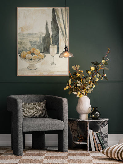 Afternoon Aperitivo still life painting in a moody green dining nook styled with florals, layered ceramics and checkered rug.