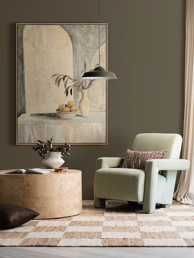 The Tuscan Villa still life art print styled with soft lighting, neutral armchair, circular side table and checkered rug.