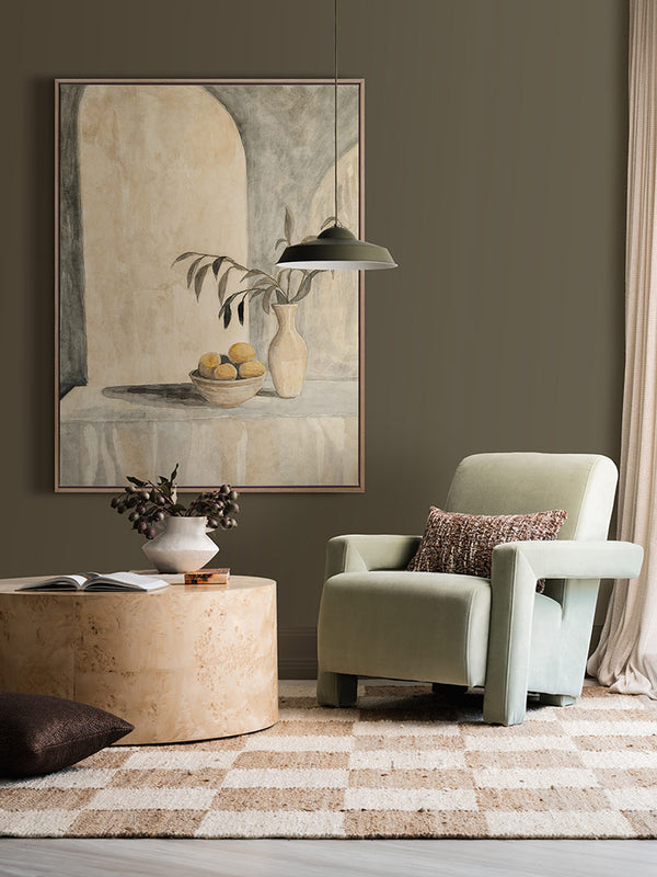 The Tuscan Villa still life art print styled with soft lighting, neutral armchair, circular side table and checkered rug.