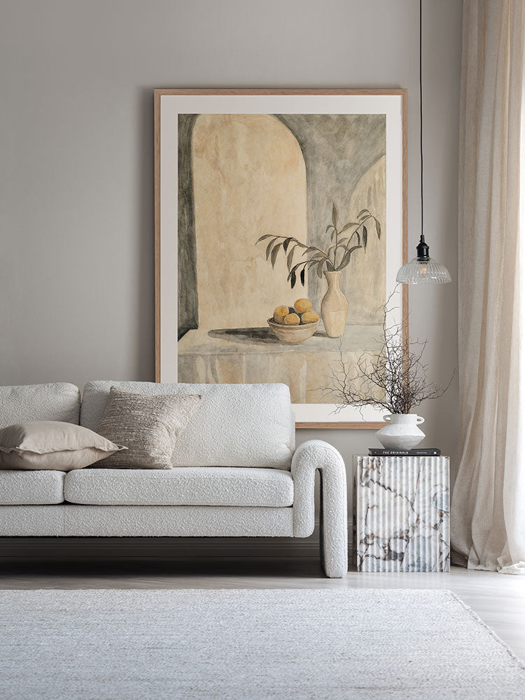 The Tuscan Villa still life art print styled with soft lighting, neutral armchair, circular side table and checkered rug.