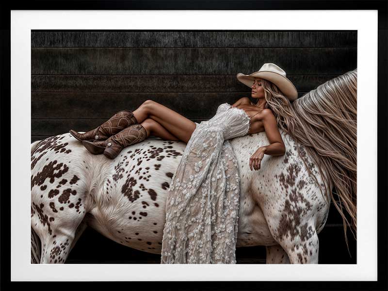 Glamorous photographic horse wall art featuring a woman in a cowboy hat and boots relaxing on a horse in earthy tones.