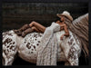 Glamorous photographic horse wall art featuring a woman in a cowboy hat and boots relaxing on a horse in earthy tones.