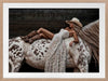 Glamorous photographic horse wall art featuring a woman in a cowboy hat and boots relaxing on a horse in earthy tones.