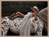 Glamorous photographic horse wall art featuring a woman in a cowboy hat and boots relaxing on a horse in earthy tones.