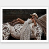 Glamorous photographic horse wall art featuring a woman in a cowboy hat and boots relaxing on a horse in earthy tones.