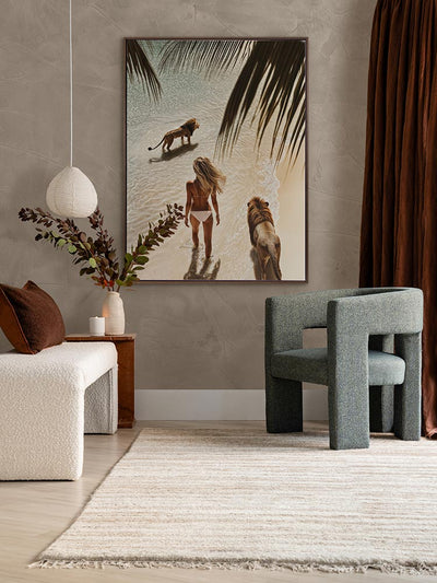Lioness artwork in a neutral living room with green armchair, white love seat, and dark red-brown curtains and cushions.