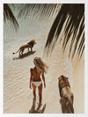 Photographic wall art of a woman and lions walking on a tropical beach with palm leaves, depicting adventurous strength.