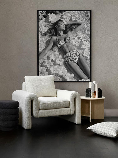 What Dreams Are Made Of black-and-white print above a white armchair side table with grey walls and soft, muted styling.