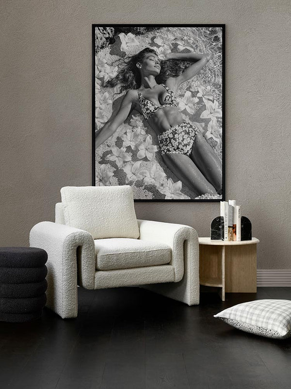 What Dreams Are Made Of black-and-white print above a white armchair side table with grey walls and soft, muted styling.