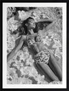 Monochrome photographic artwork of a serene woman lounging amid flowers in water, giving all the luxurious vibes.