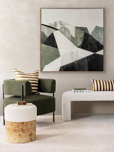 Geometric Landscape I abstract art print in a bright room with a white love seat, striped cushions, and olive green armchair.