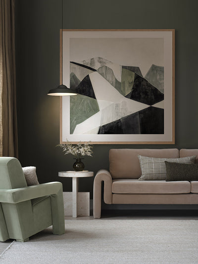 Geometric Landscape I abstract art print in a bright room with a white love seat, striped cushions, and olive green armchair.