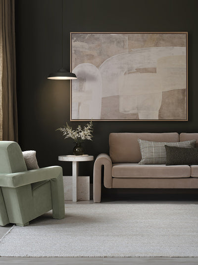 Framed Nostalgic Mood III artwork styled against a dark wall with a taupe sofa, green armchair and other modern neutral decor.